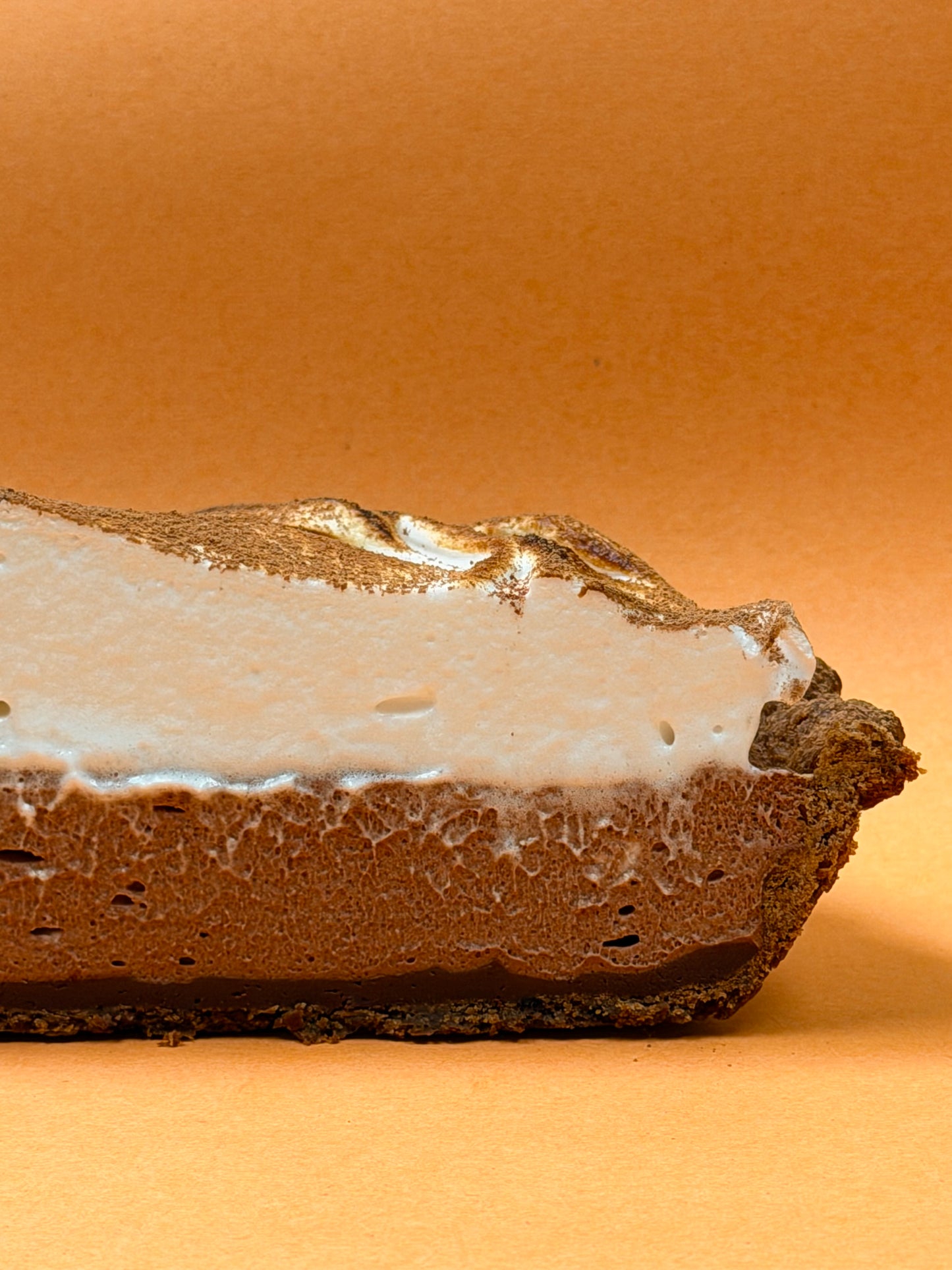 Choco Pie cross-section showing chocolate croissant crust, ganache, mousse, and meringue