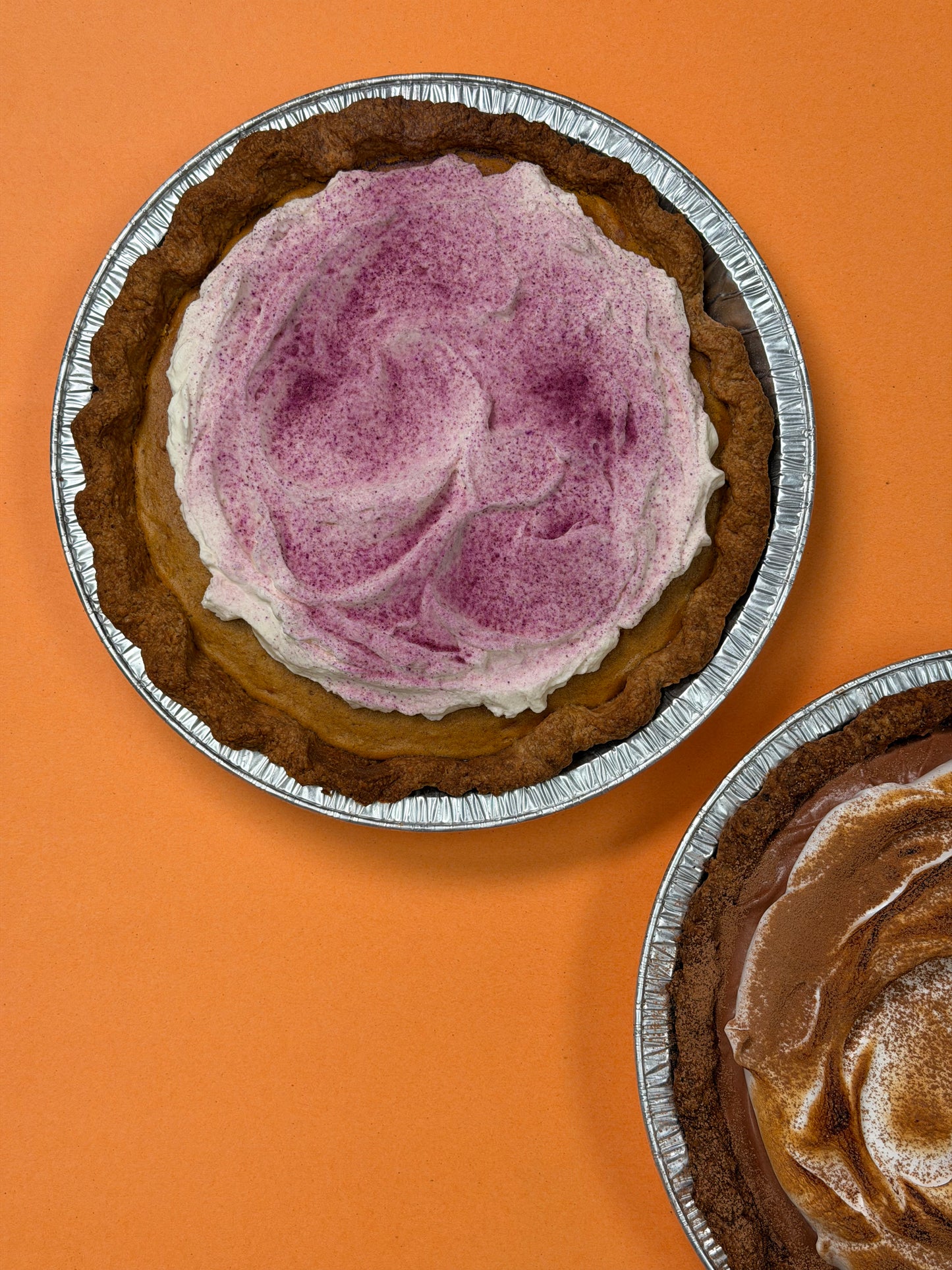 Spiced Ube Kalabasa Pie topped with whipped mascarpone cream and ube powder